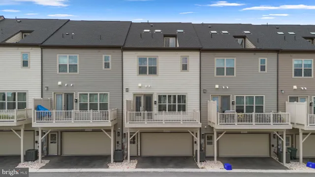 a view of a tennis ground with large trees