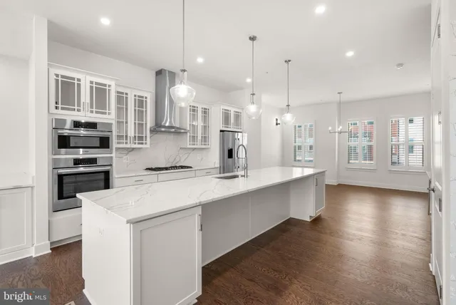 a view of an empty room and kitchen view
