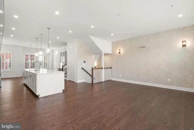 a view of a kitchen with a sink a fireplace and window