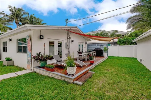 a front view of a house with a garden and parking space