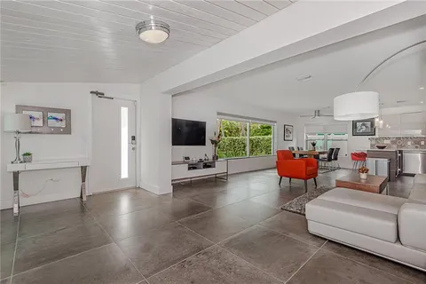 a living room with blue lights with furniture and garden view