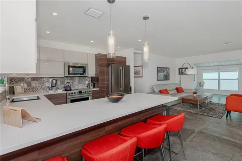 a kitchen with a sink a stove and cabinets