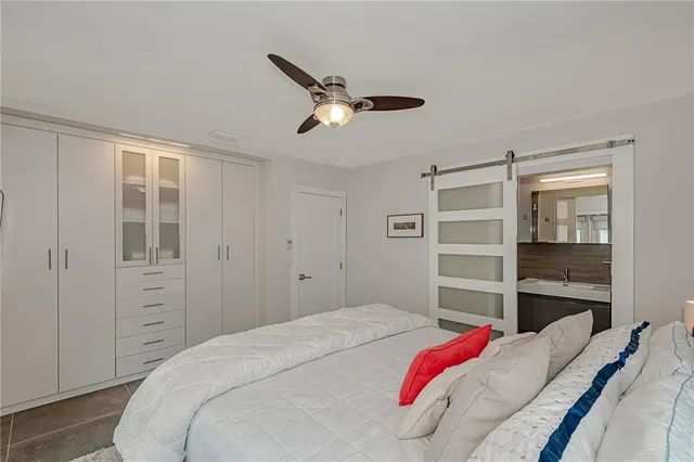 a bedroom with a large bed and a window