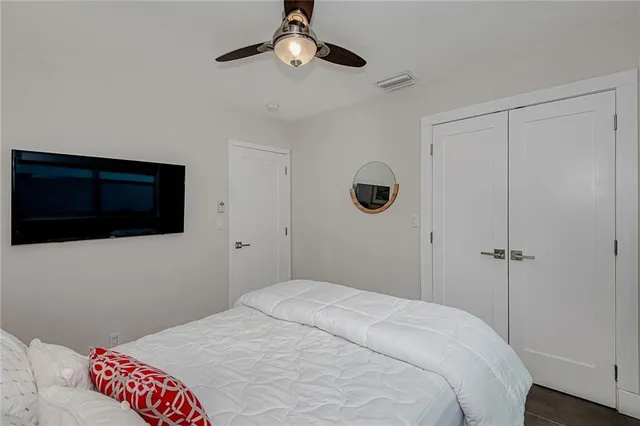 a bedroom with a bed and a large window