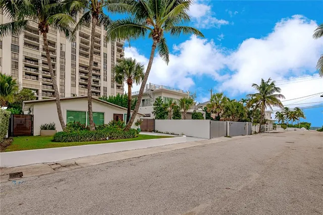 a view of a backyard with plants and a patio