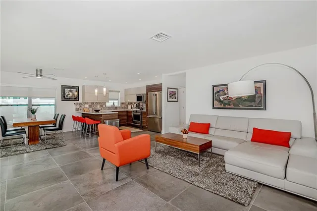 a living room with furniture a rug and a lamp