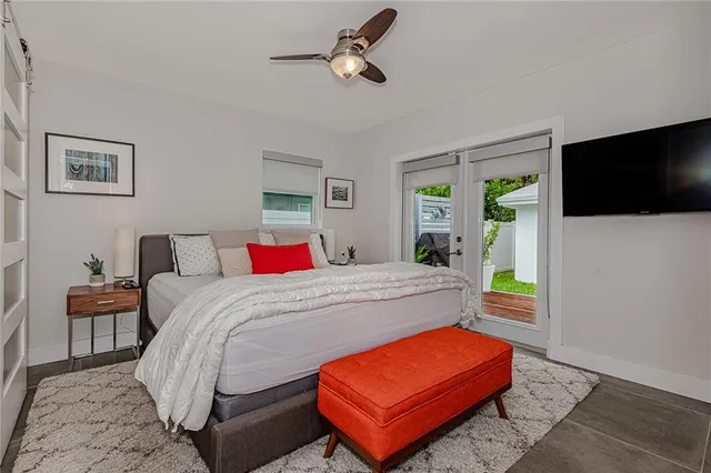 a bedroom with bed and a flat screen tv