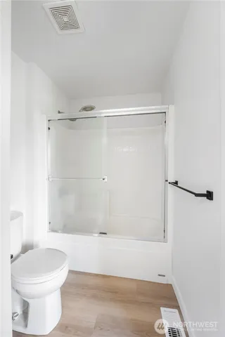 a bathroom with a shower and a toilet