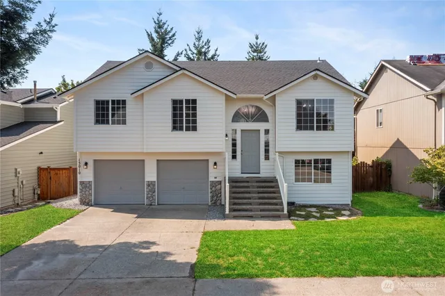 a front view of a house with a yard and garage