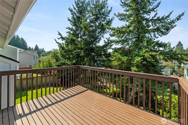 a balcony with wooden floor and fence