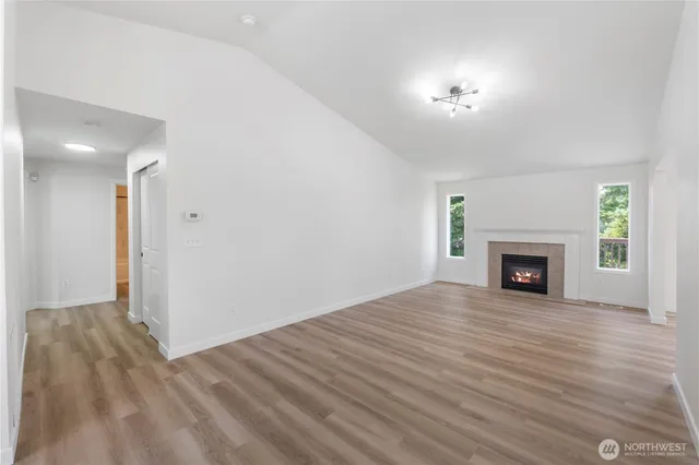 a view of a livingroom with a fireplace and a window