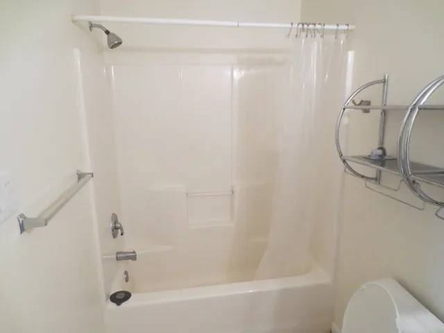 a bathroom with a shower and a shower