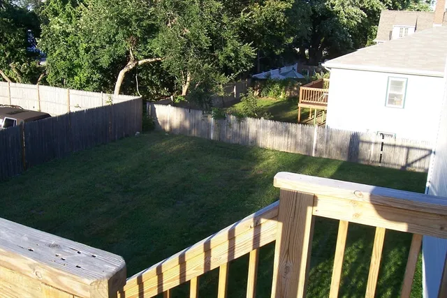 a view of a backyard with couches a table and chairs