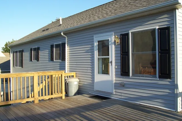 a view of a house with a wooden deck