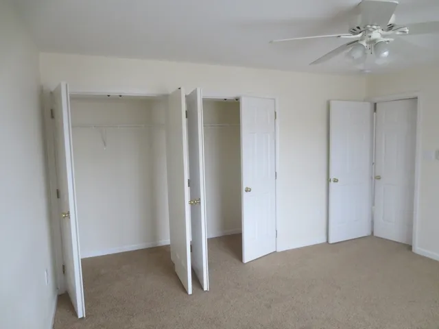 a view of an empty room with a ceiling fan
