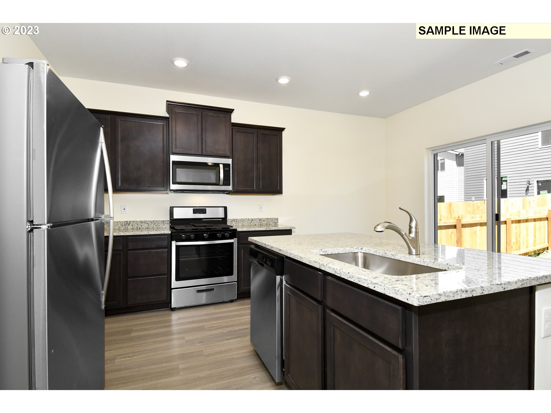 3956 Southwest Knapp Drive Gresham, OR 97080 - Photo 7 of 14 a kitchen with kitchen island a sink stainless steel appliances and cabinets