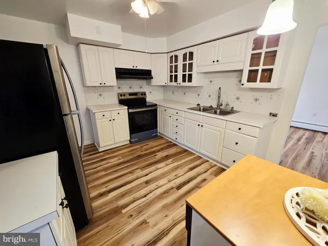 a kitchen with stainless steel appliances a refrigerator sink and stove