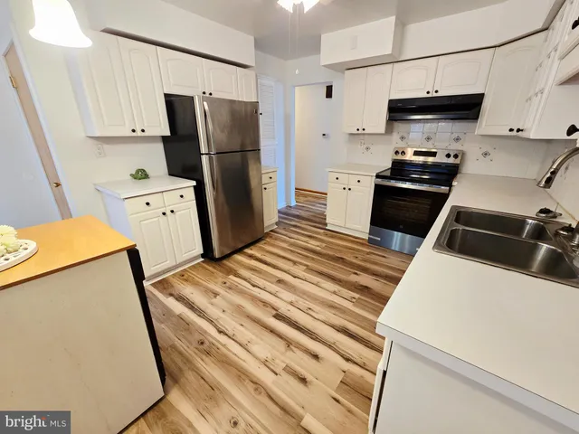 a kitchen with a sink appliances and cabinets