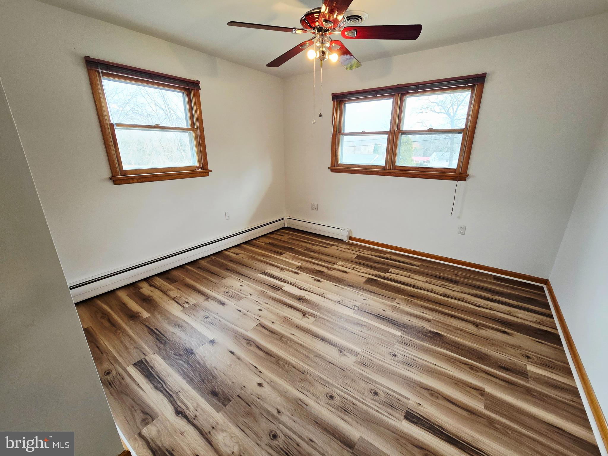 15421 Shamrock Road Southwest Cumberland, MD 21502 - Photo 18 of 39 a view of an empty room with wooden floor and a window