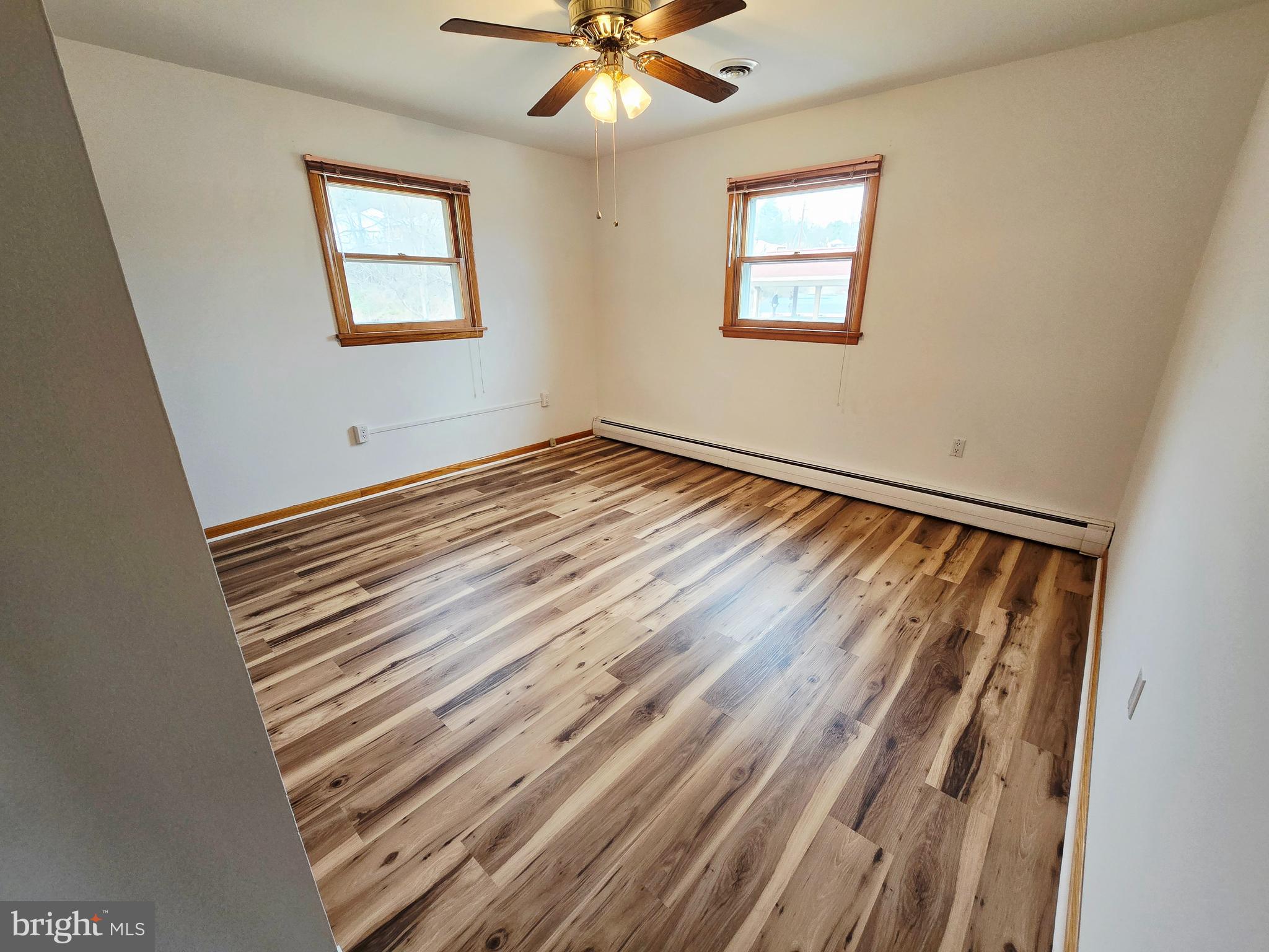 15421 Shamrock Road Southwest Cumberland, MD 21502 - Photo 22 of 39 a view of an empty room with wooden floor and a window