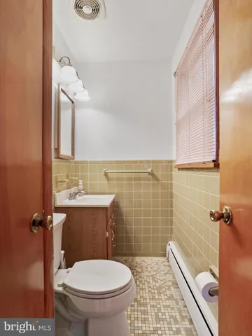 a bathroom with a sink toilet and mirror