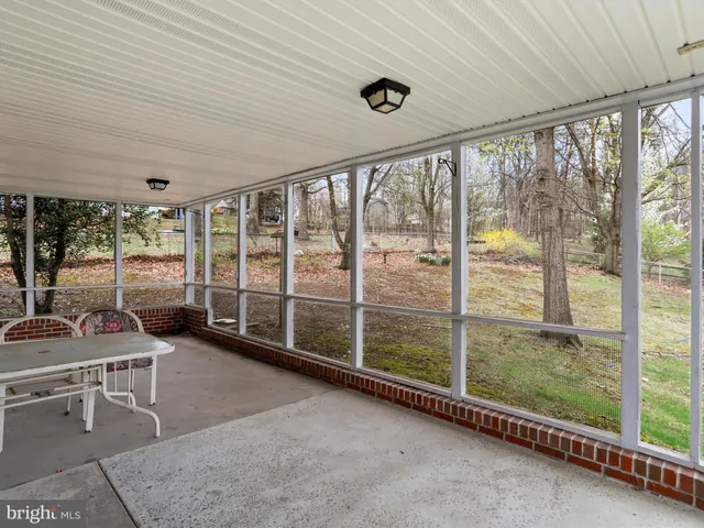 a view of an empty room with exposed radiator and fireplace