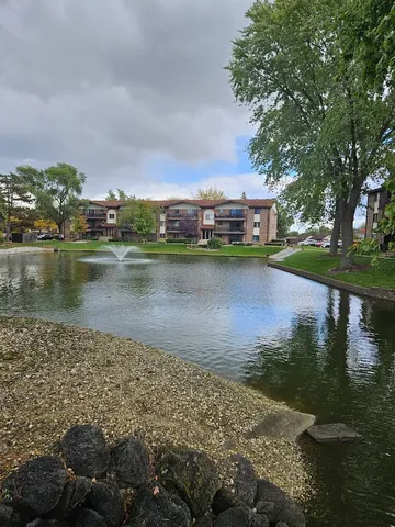 a view of a lake with houses in the background