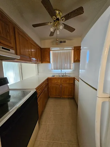 a kitchen with a sink appliances and cabinets