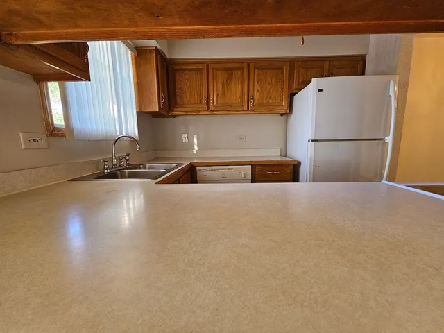 a kitchen with a refrigerator and a sink