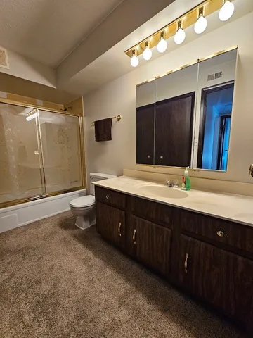 a bathroom with a double vanity sink and a large mirror