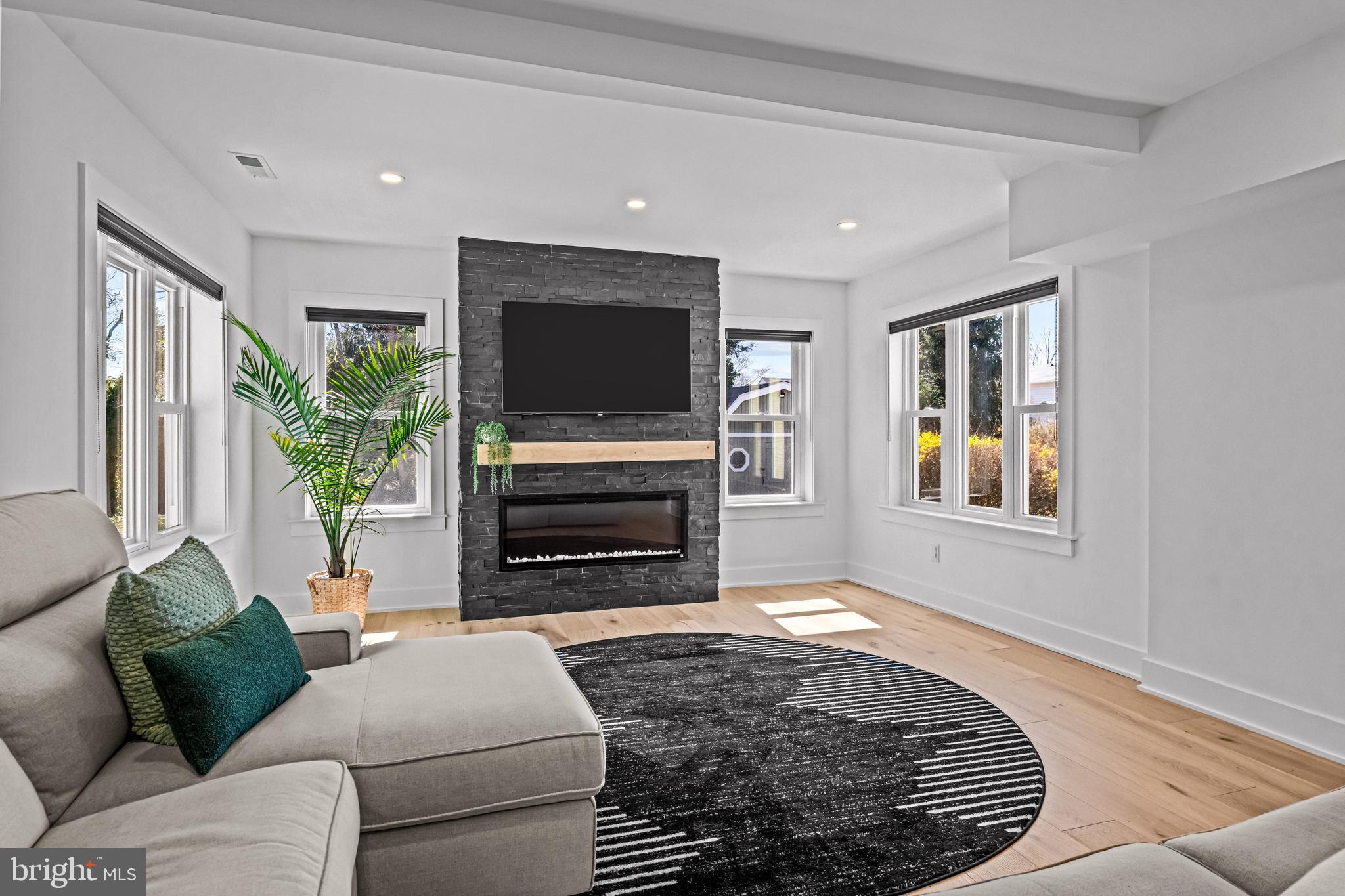 1828 Prospect Ridge Boulevard Haddon Heights, NJ 08035 - Photo 21 of 57 a living room with furniture a flat screen tv and a fireplace