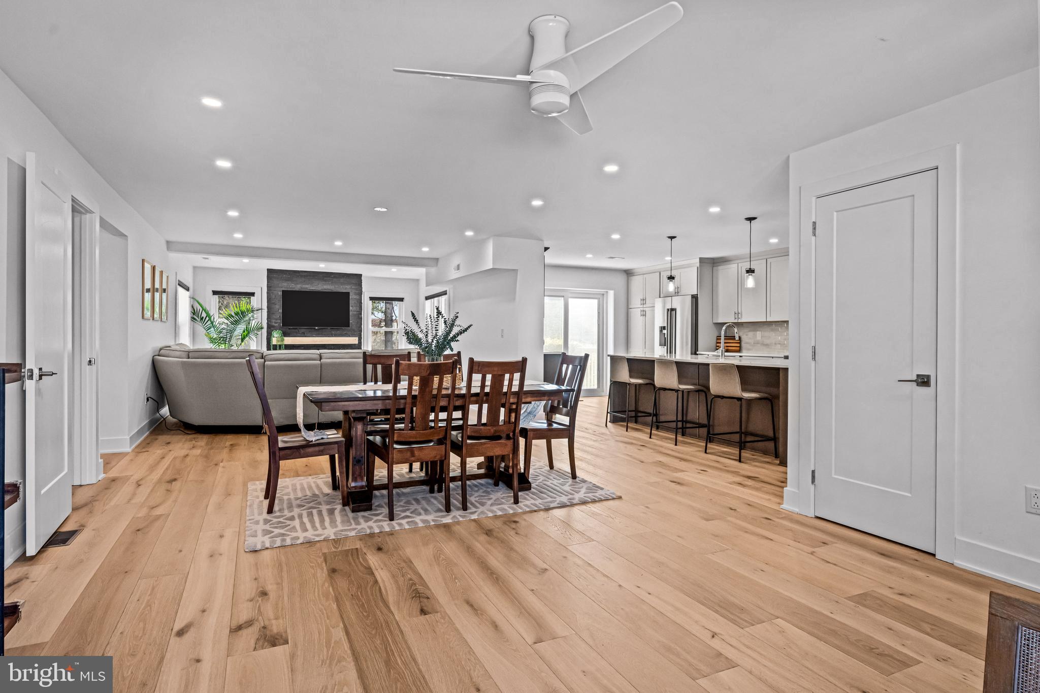 1828 Prospect Ridge Boulevard Haddon Heights, NJ 08035 - Photo 7 of 57 a view of a dining room and livingroom with furniture wooden floor a rug a fireplace