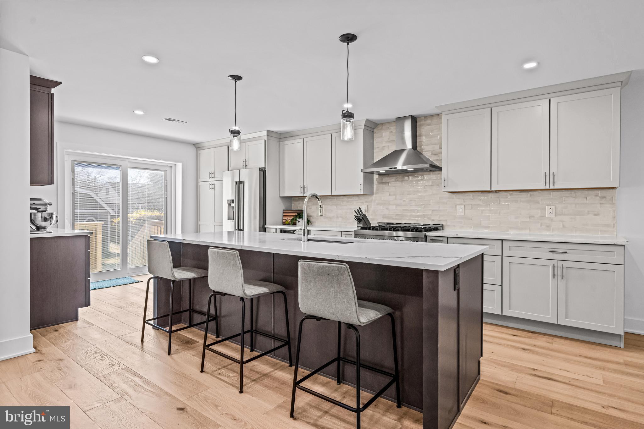 1828 Prospect Ridge Boulevard Haddon Heights, NJ 08035 - Photo 10 of 57 a kitchen with stainless steel appliances granite countertop a stove a sink dishwasher a refrigerator with white cabinets and wooden floor