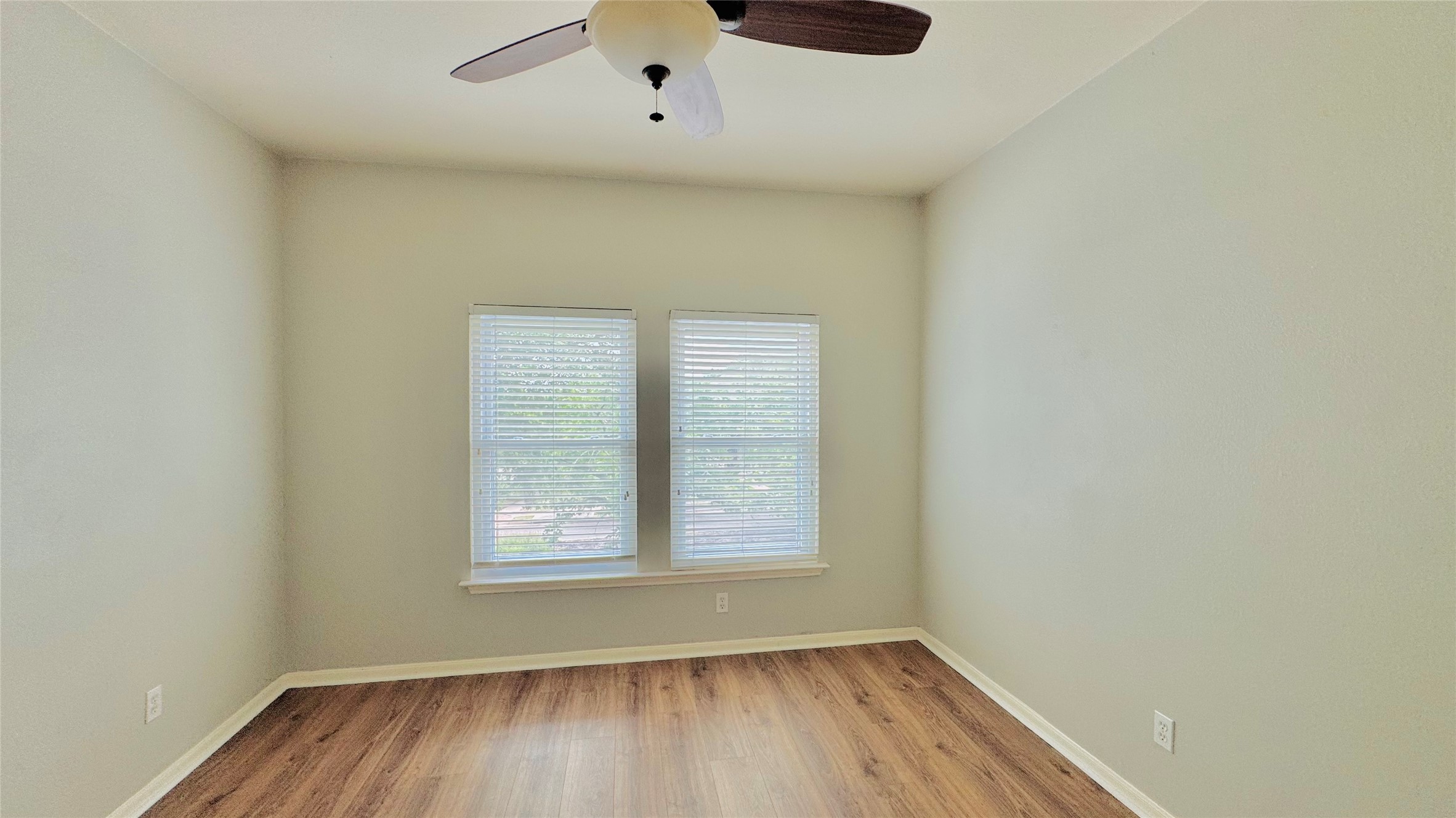 401 Witte Road Kyle, TX 78640 - Photo 22 of 24 Bedroom 4-A well-lit room featuring durable wood flooring and an essential ceiling fan for comfort.