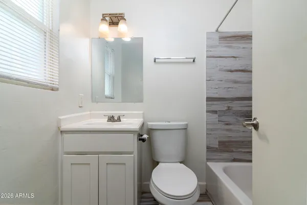 a bathroom with bathtub and shower