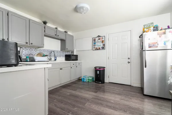 a kitchen with a sink cabinets and wooden floor