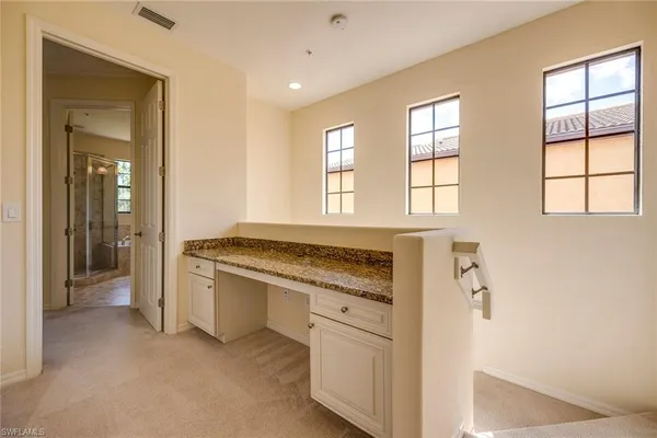 a bathroom with a granite countertop sink a toilet and bathtub