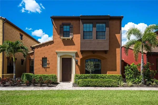 a front view of a house with a garden and plants