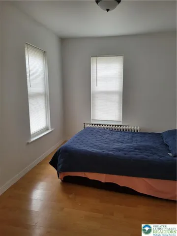 a spacious bedroom with a bed and window