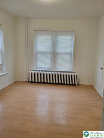 an empty room with wooden floor