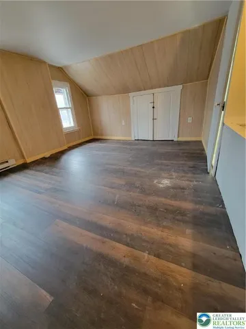 a view of a livingroom with wooden floor and window