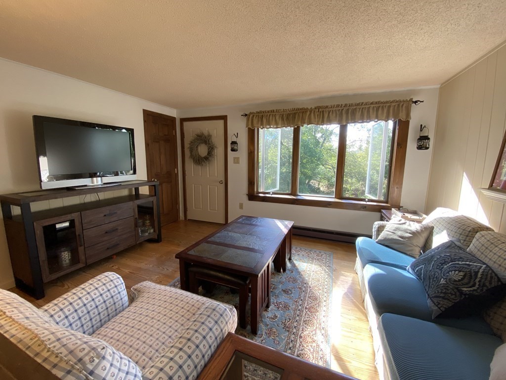 370 Nichols Road Barre, MA 01005 - Photo 3 of 25 a living room with furniture and a flat screen tv