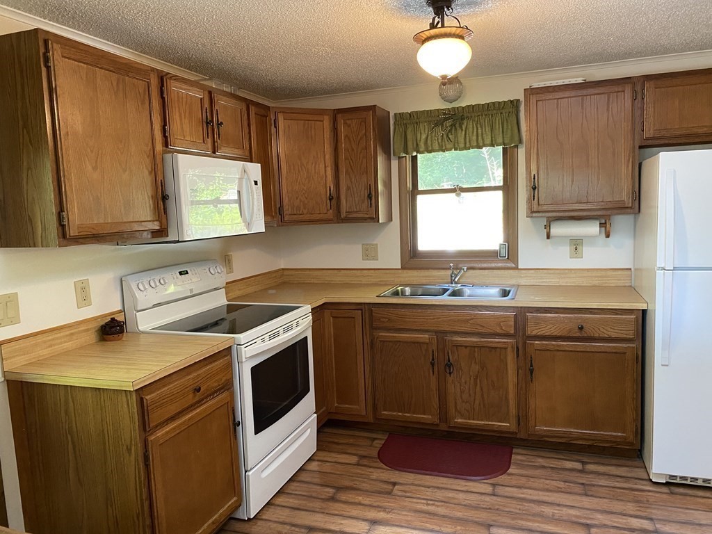 370 Nichols Road Barre, MA 01005 - Photo 6 of 25 a kitchen with stainless steel appliances granite countertop a sink stove and refrigerator