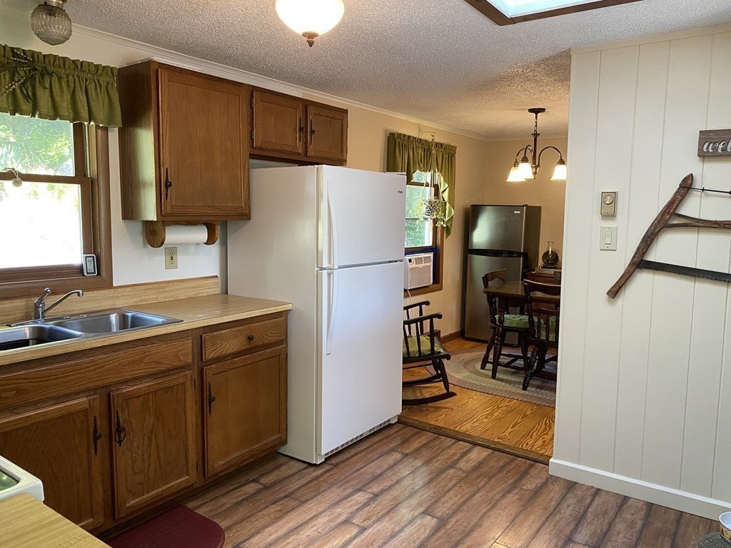 370 Nichols Road Barre, MA 01005 - Photo 7 of 25 a kitchen with a refrigerator a sink and wooden floor