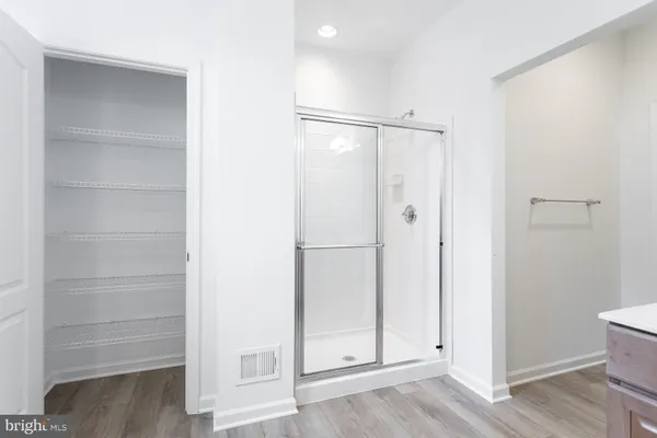 a view of walk in closet with empty racks