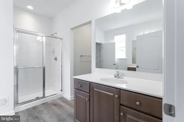 a bathroom with a double vanity sink and mirror
