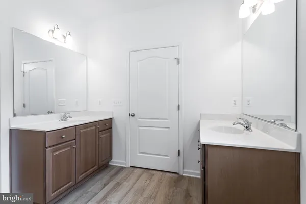 a bathroom with a double vanity sink and mirror