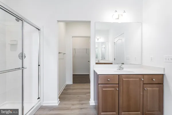 an empty room with white cabinets and empty shelves