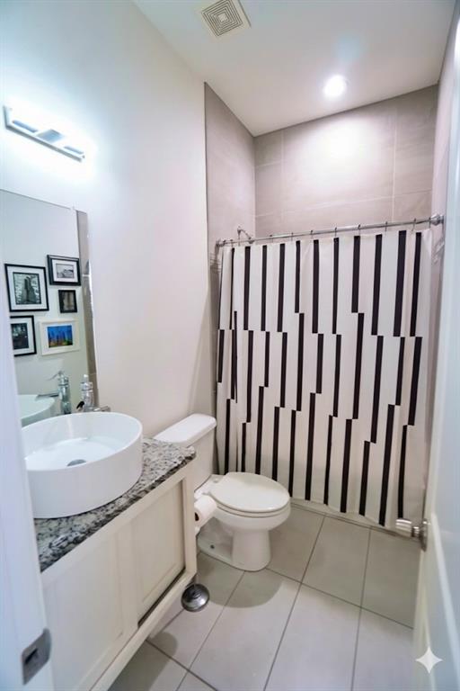 1439 Stella Avenue Dallas, TX 75216 - Photo 12 of 13 a bathroom with a granite countertop sink and a mirror