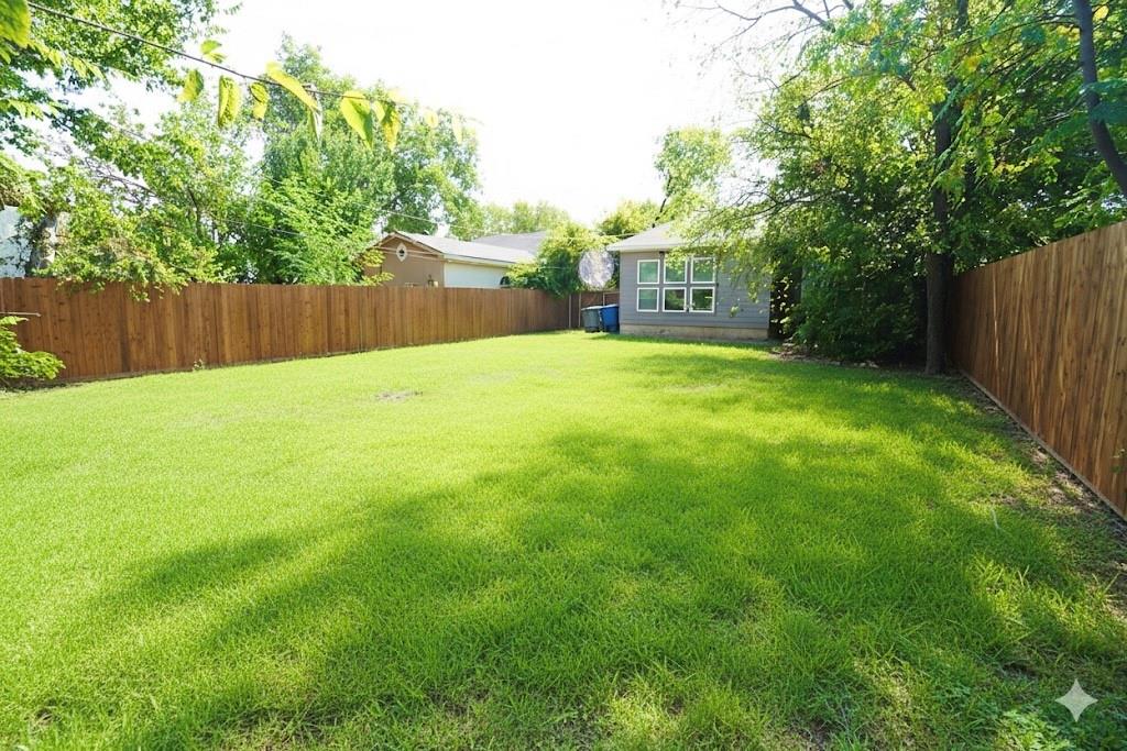 1439 Stella Avenue Dallas, TX 75216 - Photo 13 of 13 a view of a yard with a house and large trees